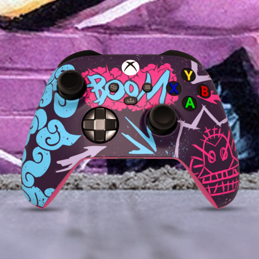 "Custom Arcane inspired Xbox Series X controller with vibrant graffiti art design, featuring bright blue, pink, and purple street-style graphics with 'BOOM' text on the touchpad, displayed in front of an urban graffiti wall."