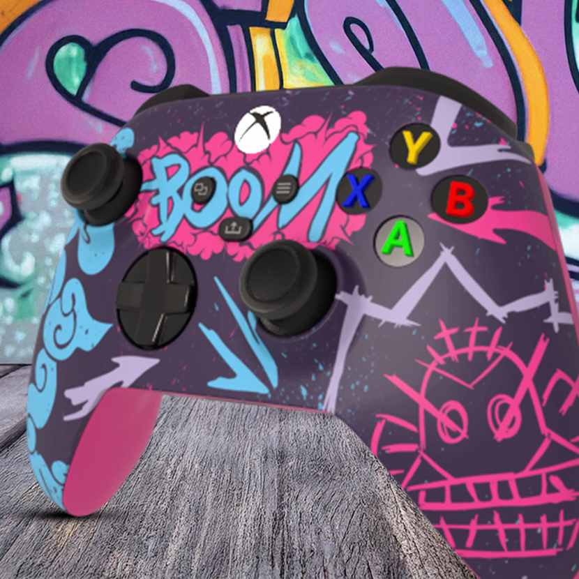 "Custom Arcane inspired Xbox Series X controller with vibrant graffiti art design, featuring bright blue, pink, and purple street-style graphics with 'BOOM' text on the touchpad, displayed in front of an urban graffiti wall."